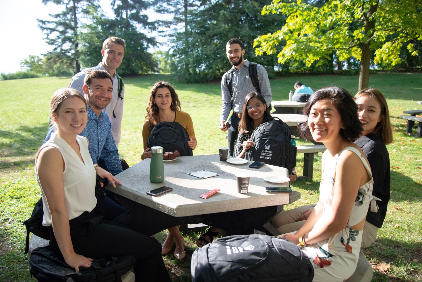 Medicine students around a picnic table outside