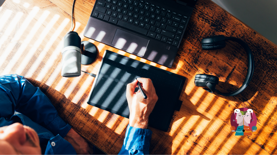 a person writing and looking at his computer