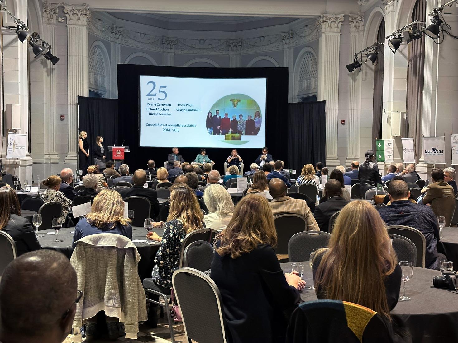 many people sitting in huguette label space during the gala