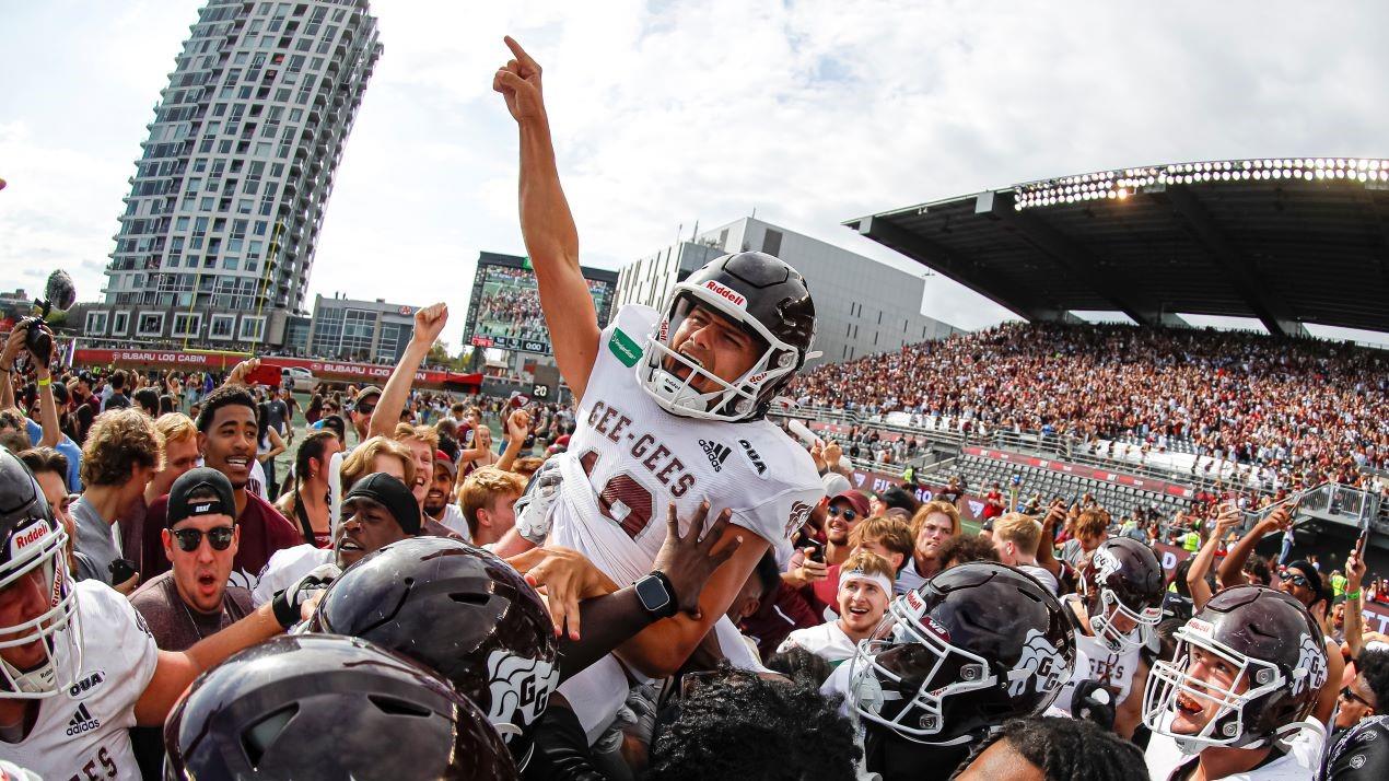 Gee Gees football players celebrate Panda Game win.