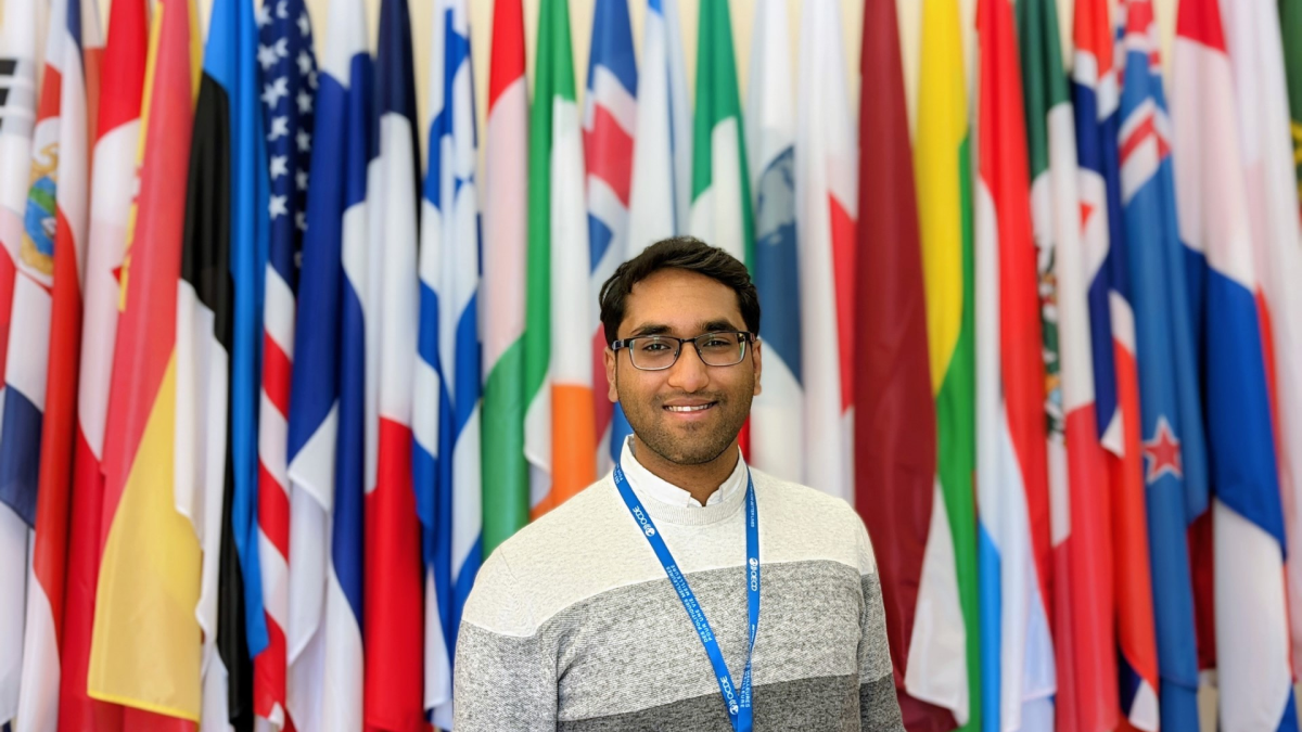 Anvesh Jain in front international flags