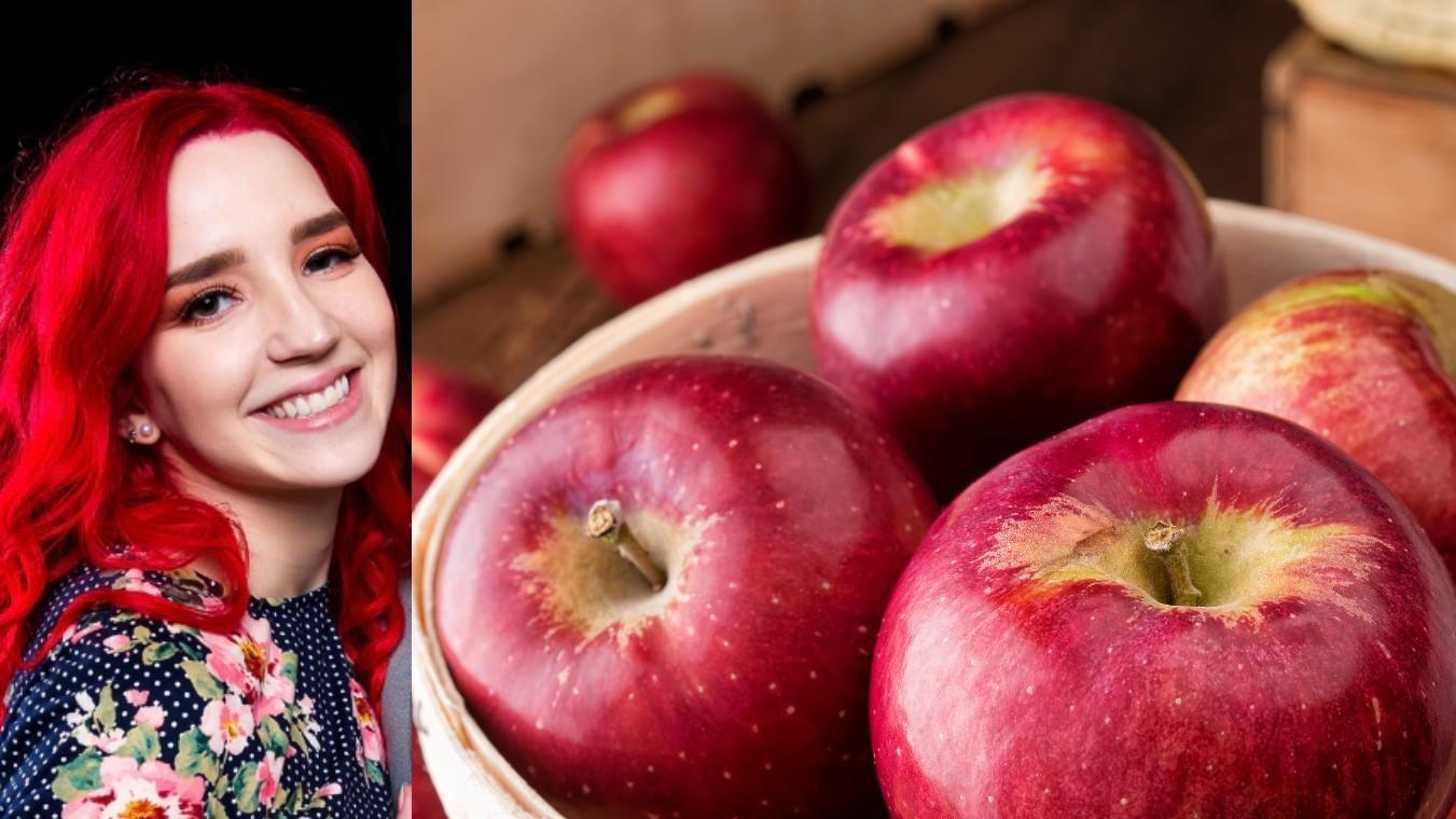 Apples in and outside a basket w/ woman