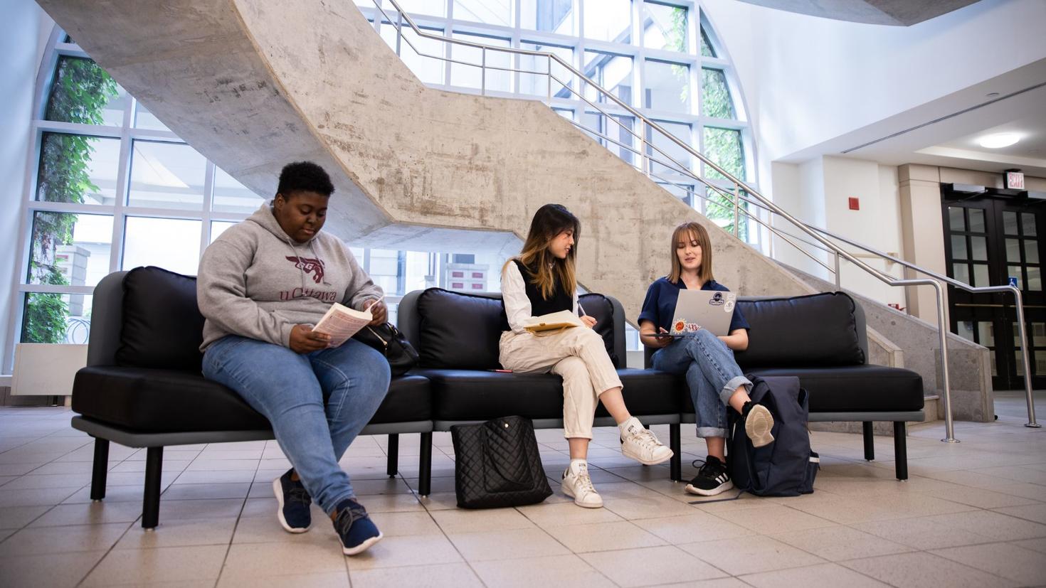 Students sitting together on campus. 