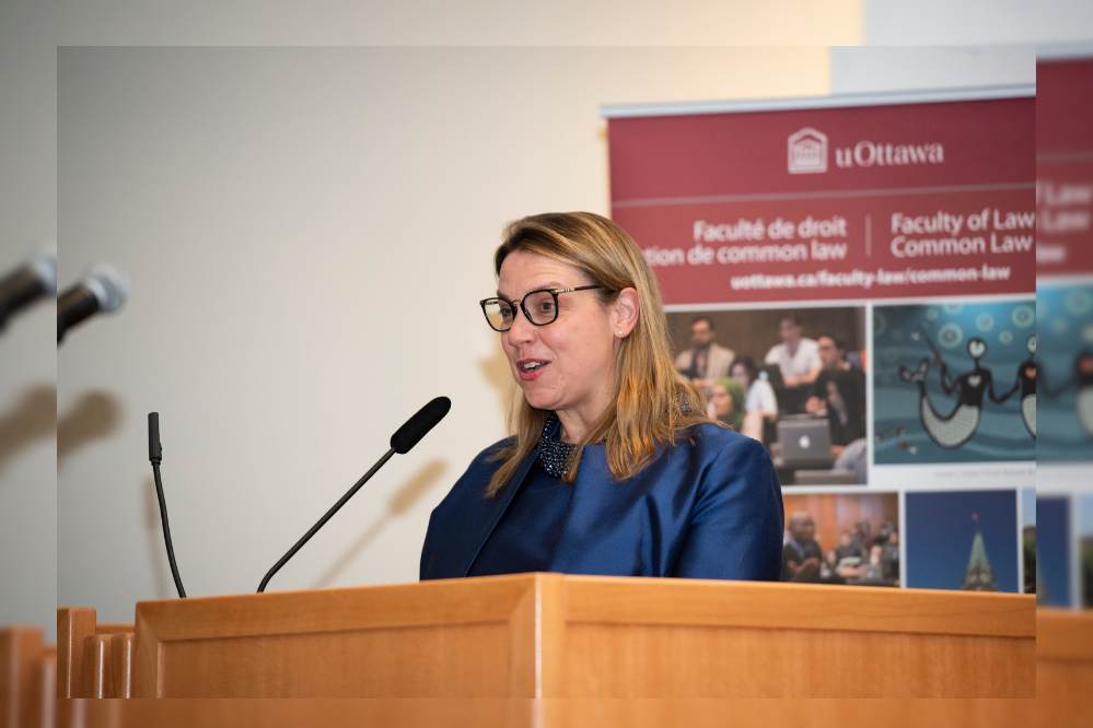 A woman stands at a podium