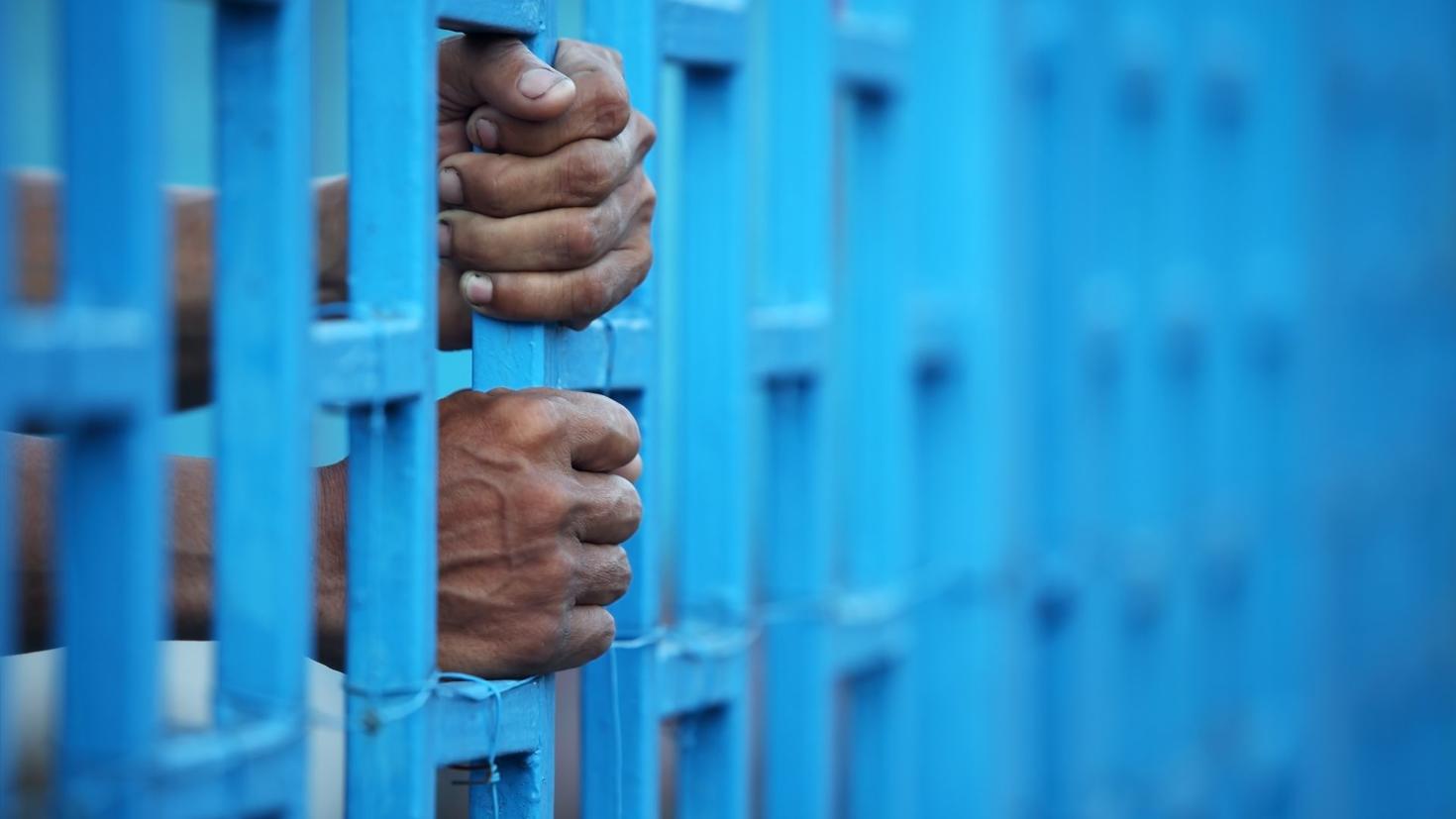 hands on prison bars