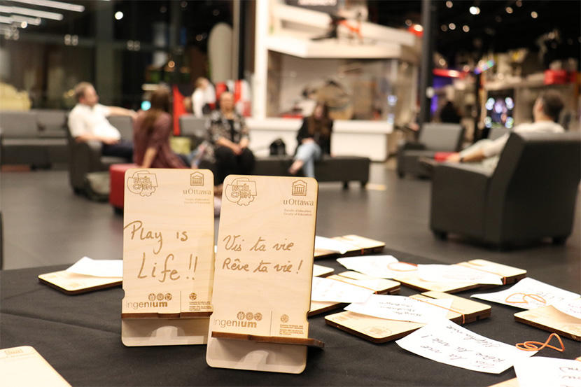 Laser-engraved recycled wood phone holders.