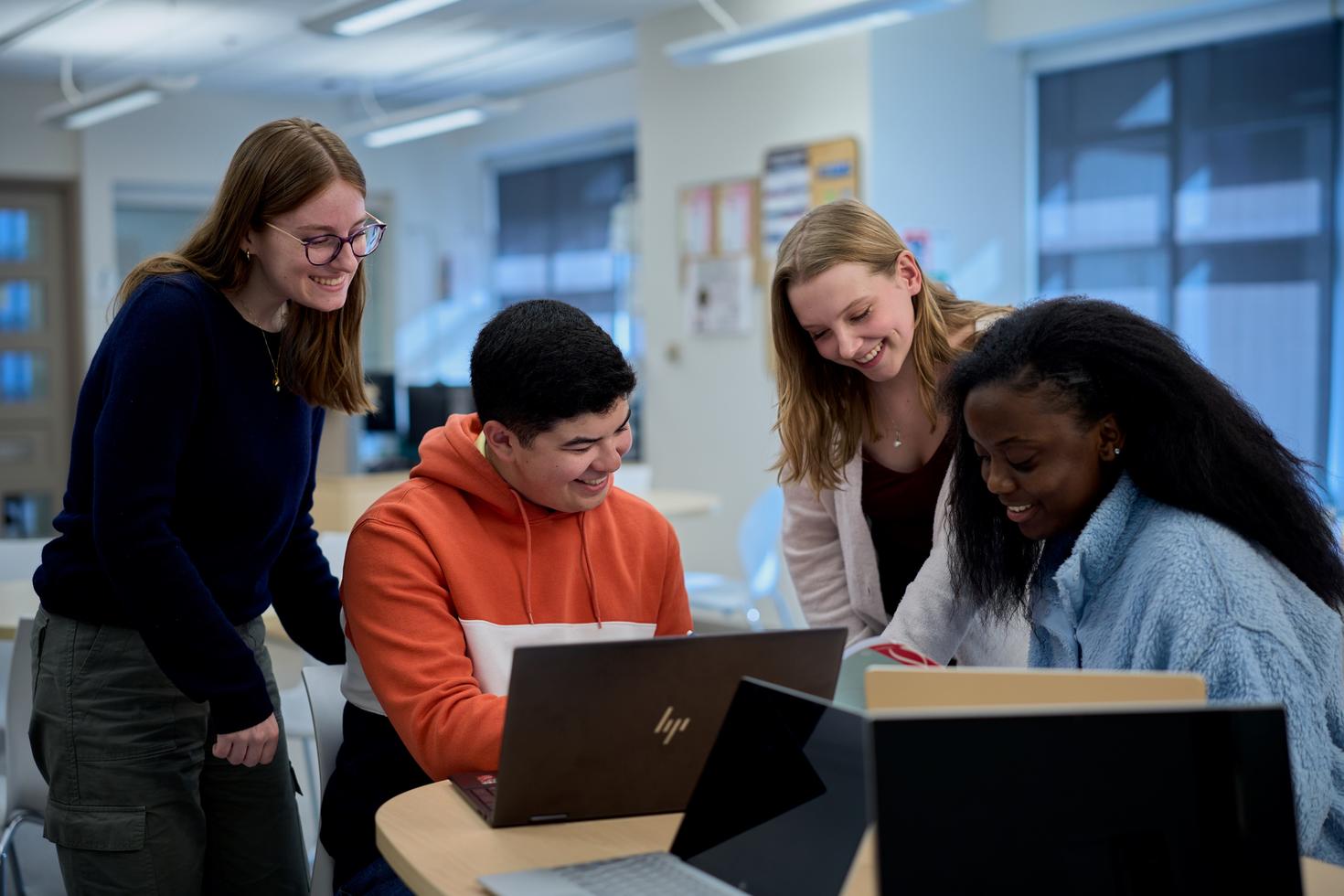 Students working in front of a laptop