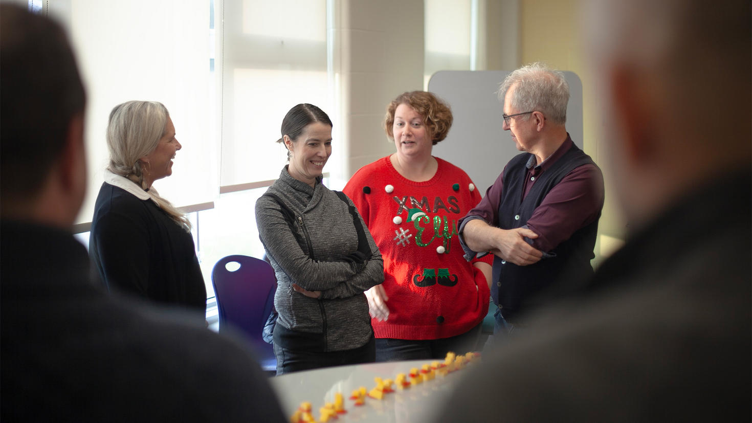 Educators in conversation next to a table with Lego ducks