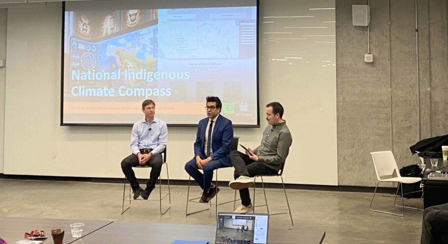 Joseph Wabegijig, Colin Rennie and Darren Sutherland sitting in front of a room chatting