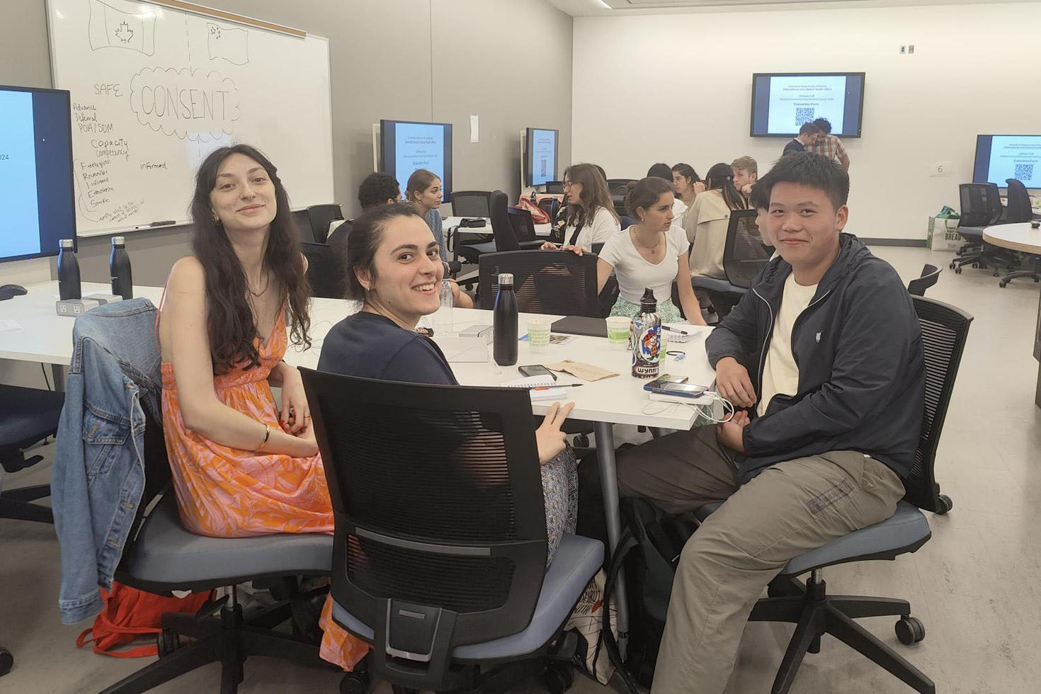 A room full of students grouped together and having discussions.