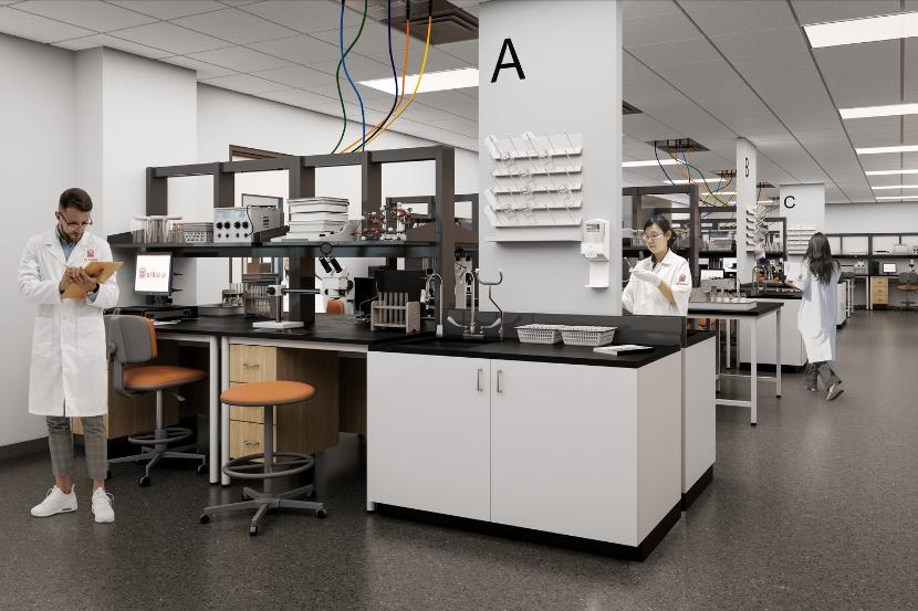 Laboratory with desks, equipment and people wearing white coats.