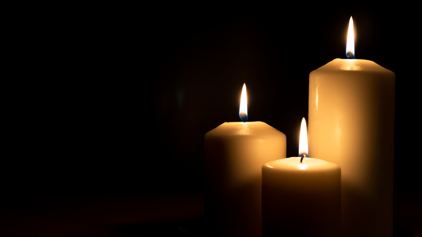 Three lit white candles