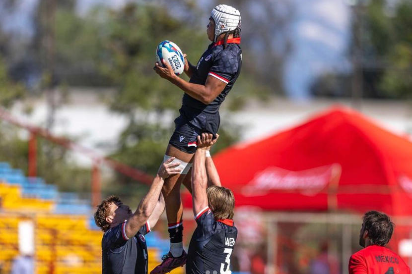 Two Gee-Gees rugby players hoist a third player into the air during a lineout.