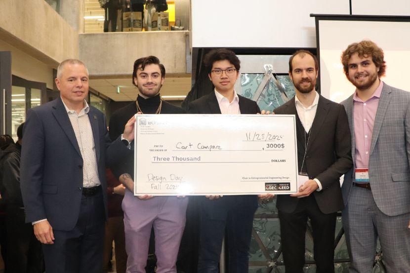 A group holding a prize money certificate.