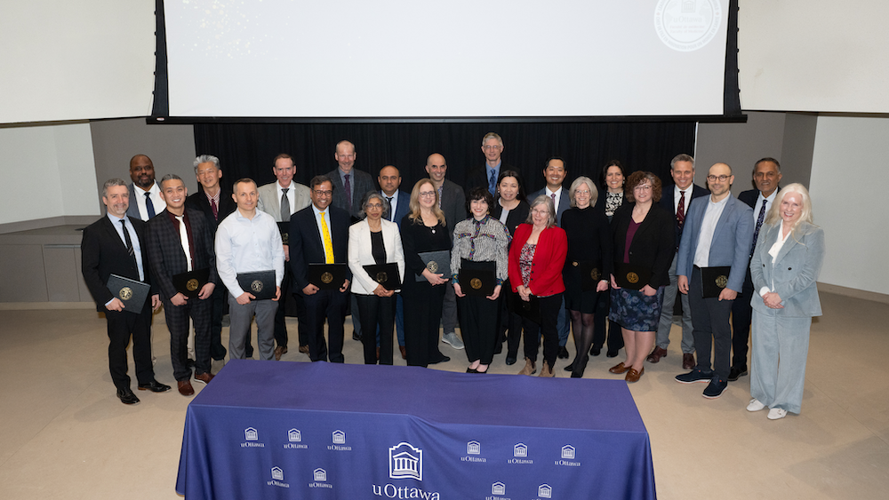 A group of university professors holding certificates