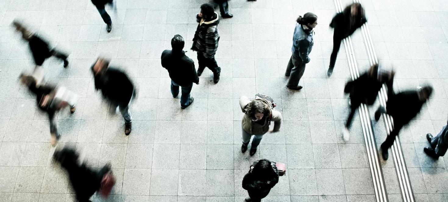 A blurry picture of people walking.