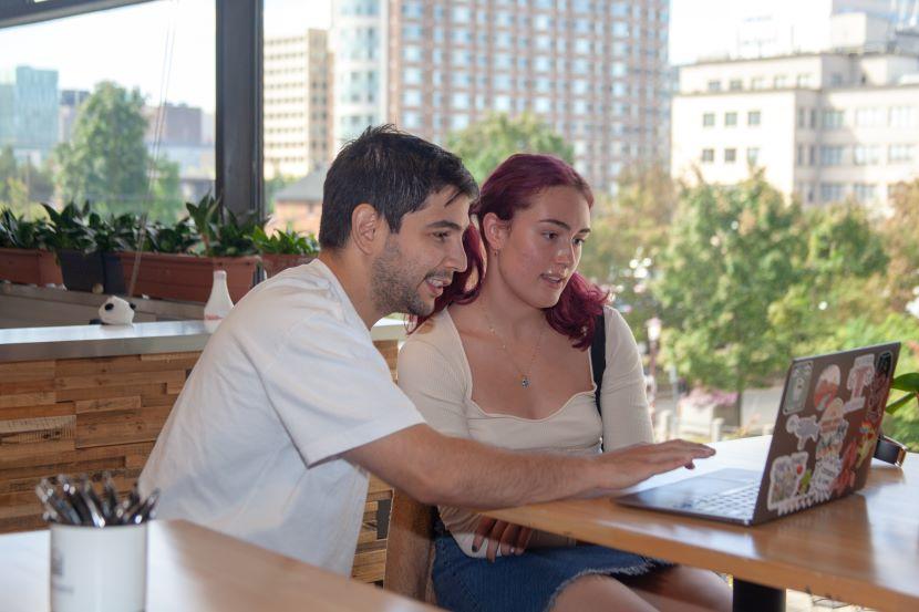 Two students looking at a laptop.