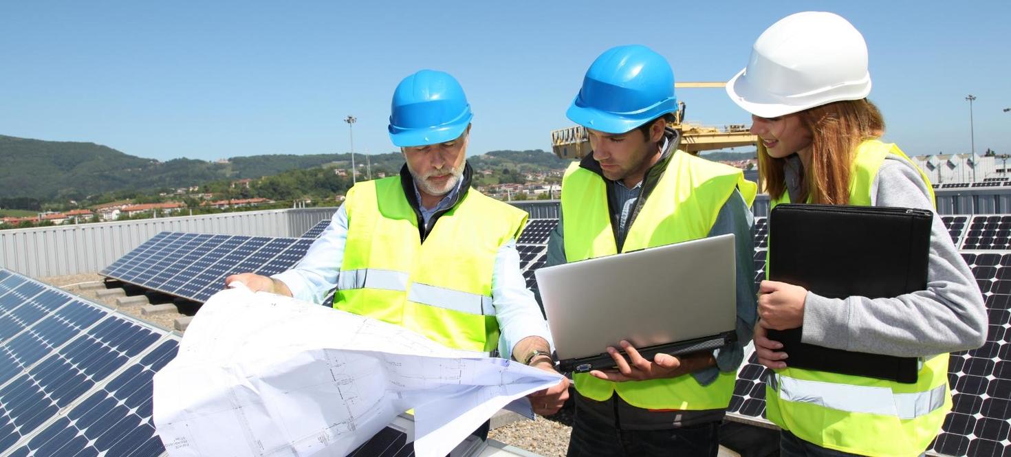 A group of engineers holding looking at a project.
