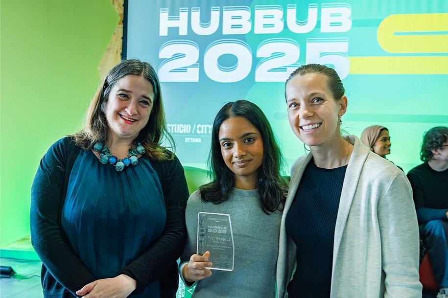 The winner for top project from the University of Ottawa stands with a city councillor and a city staff member