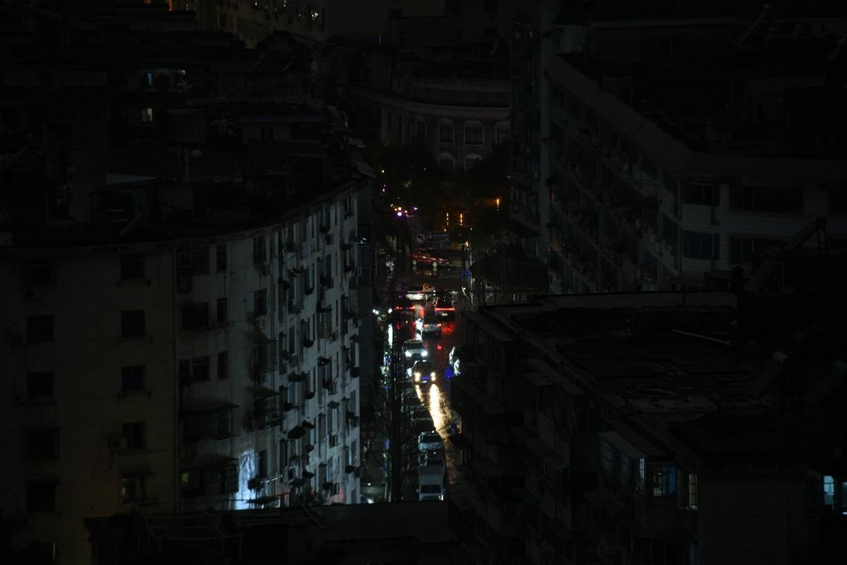 Cars driving through blacked out city