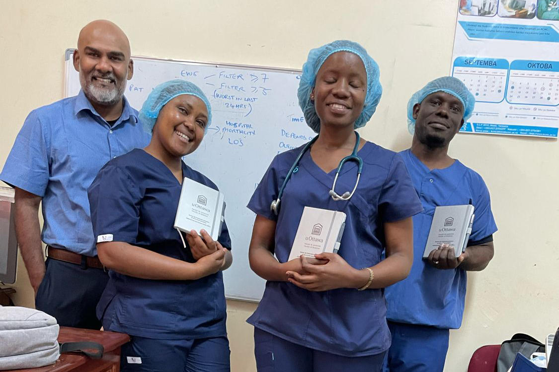 Four people standing in a medical clinic.