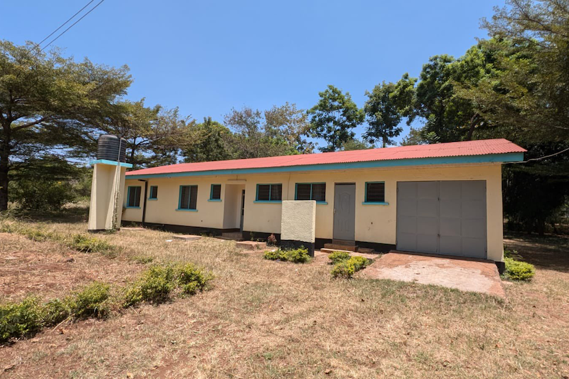A yellow house in a rural environment.