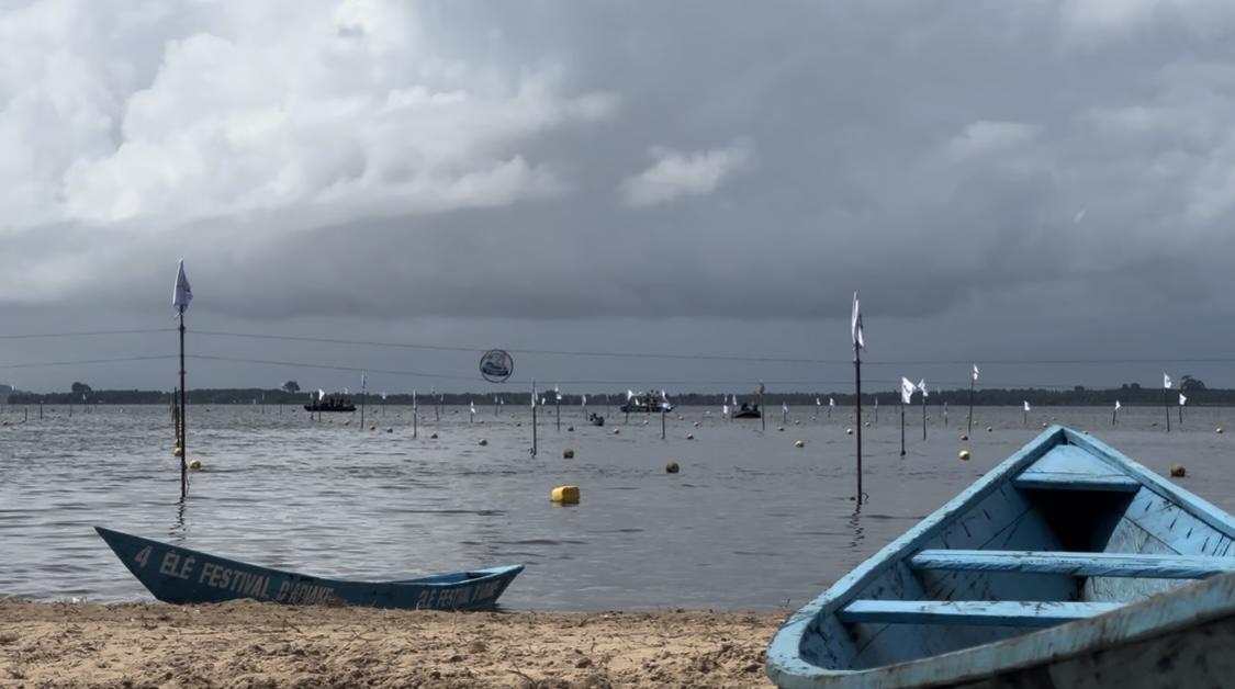 Boats lie still on a misty beach.