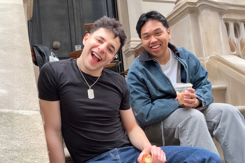 two people sitting relaxing on the steps of a building.