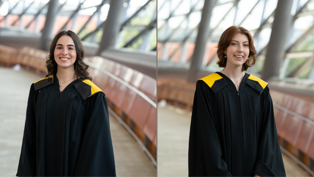 : Side-by-side portraits of Amélie Mainville (left) and Jessica Borean (right), both wearing black graduation gowns with yellow faculty hoods and standing in a bright, modern hallway with curved glass walls.