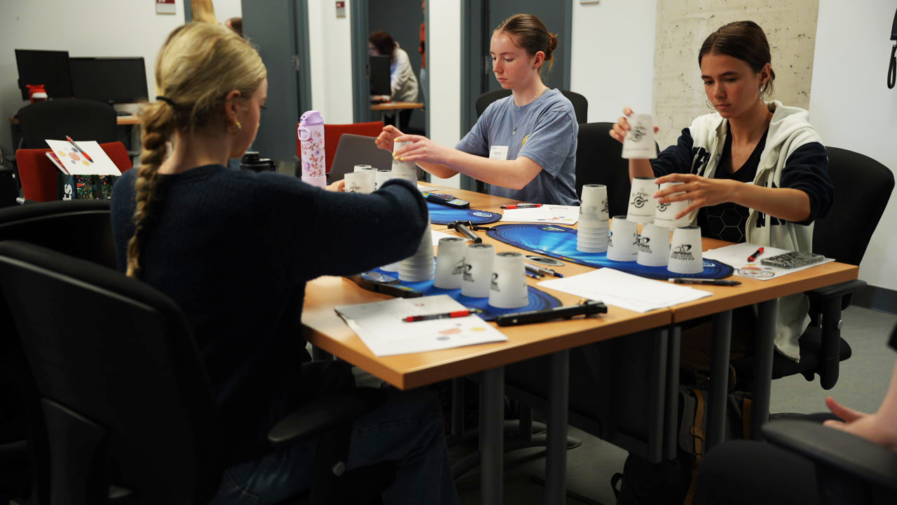 Students experimenting with stacking cups