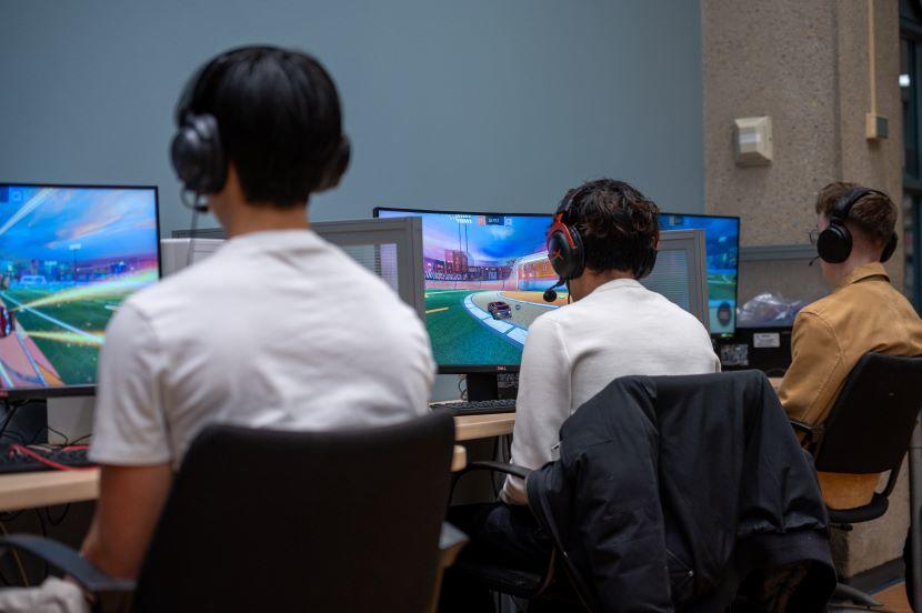 Three students playing video games.