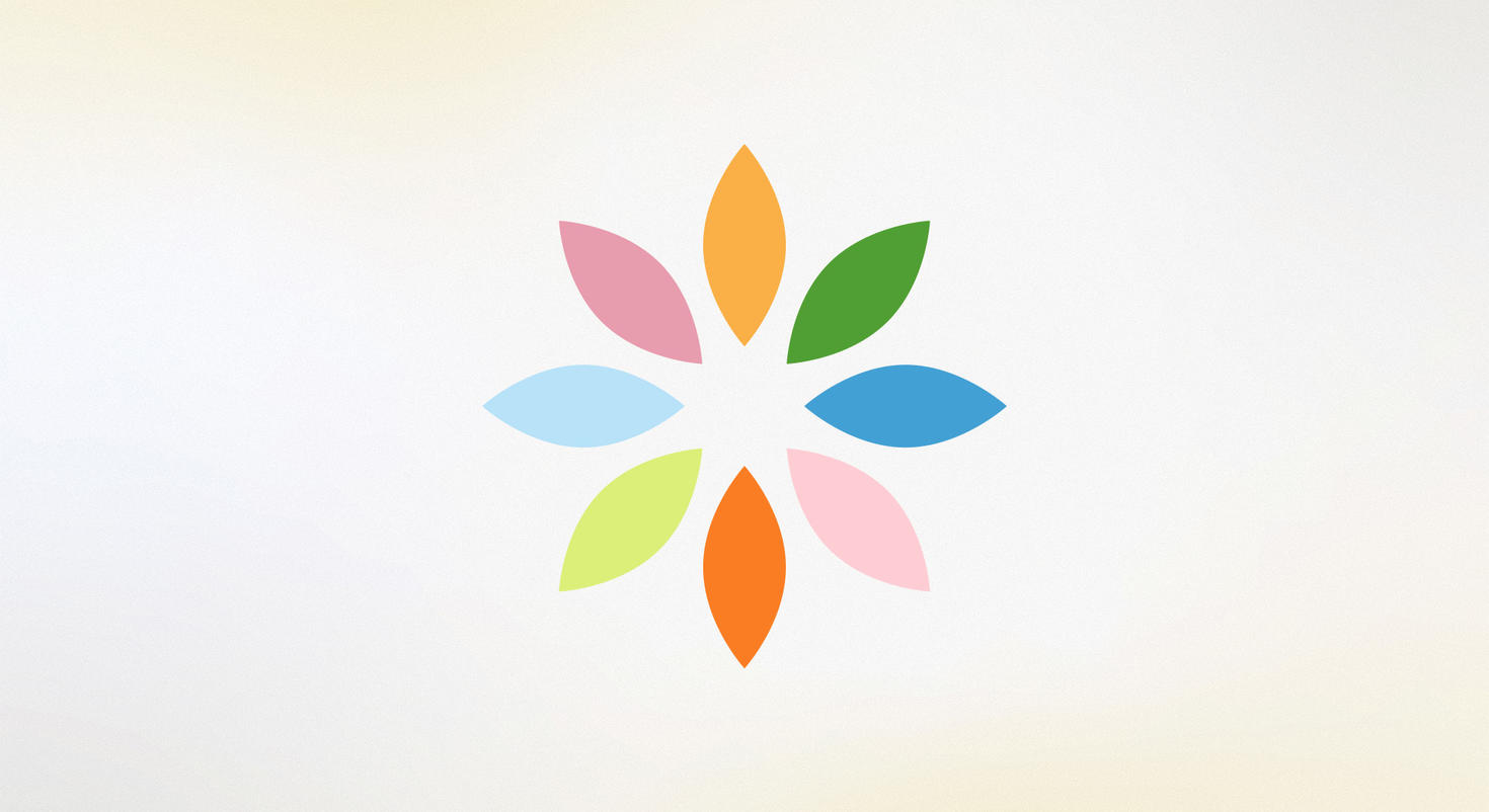 The Wellness logo, which consists of eight petals, each one in a different pastel color.