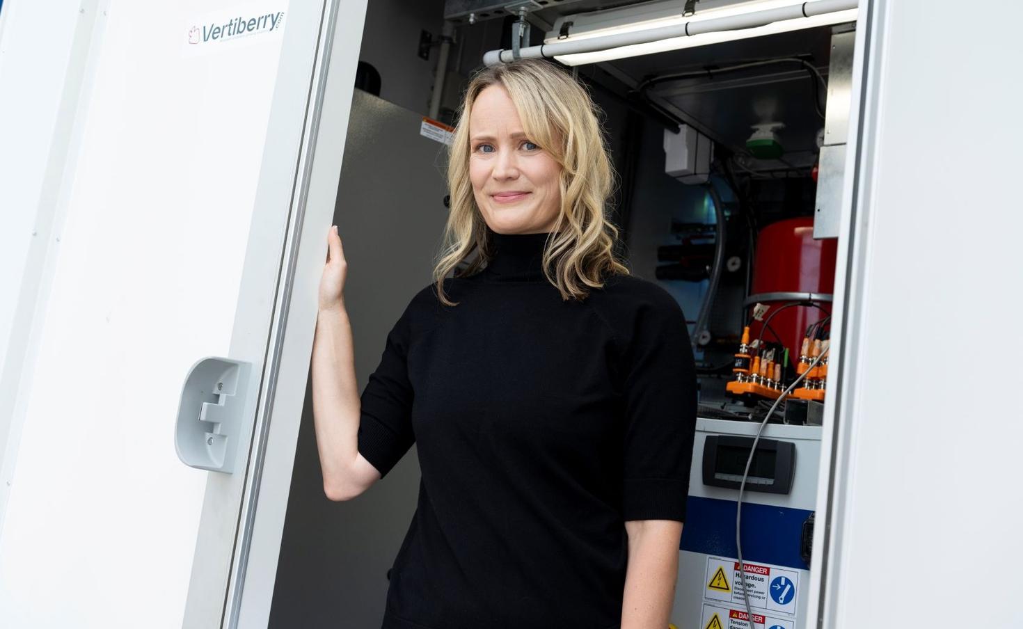 Professor Allyson MacLean stands in the doorway of the Vertiberry vertical farming centre, where she leads the True North Berries project. This initiative is developing sustainable, year-round strawberry production in Canada.