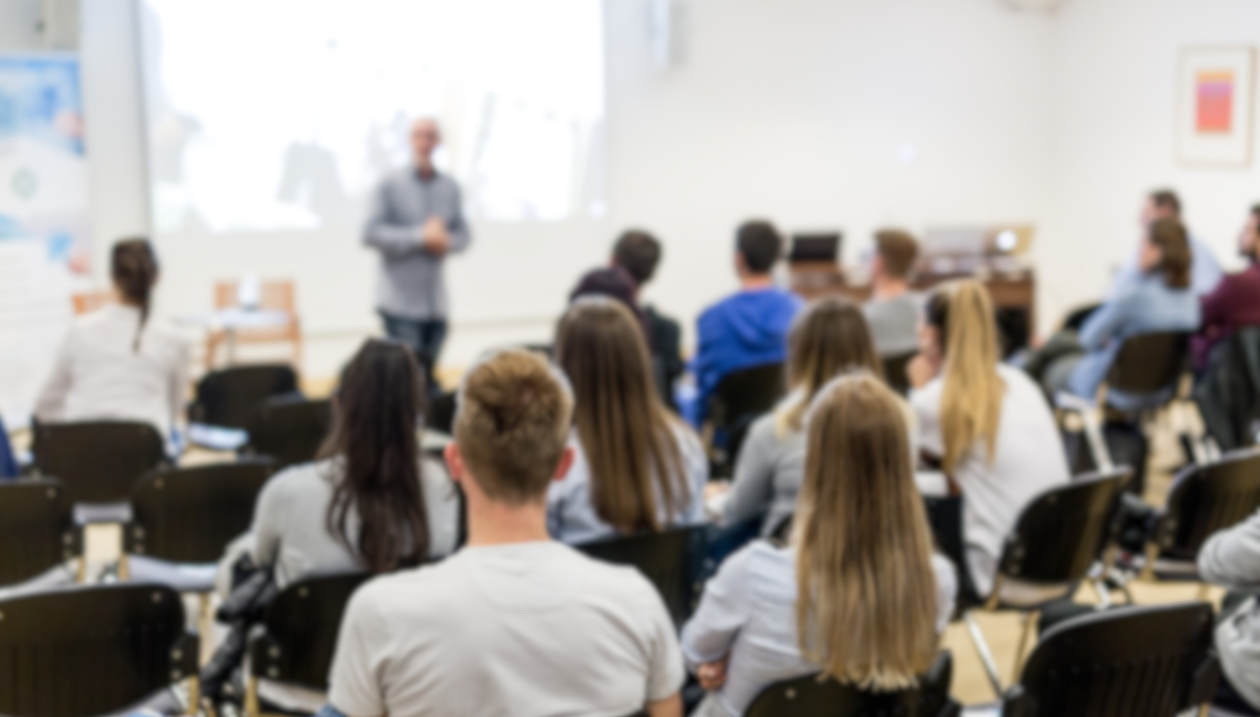 Classroom full of students seen from behind