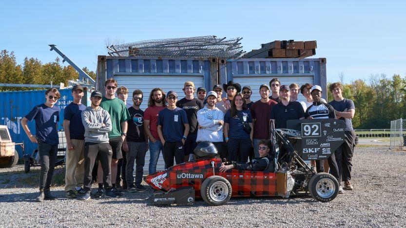 Members of the Formula uOttawa club pose next to their small racecar.