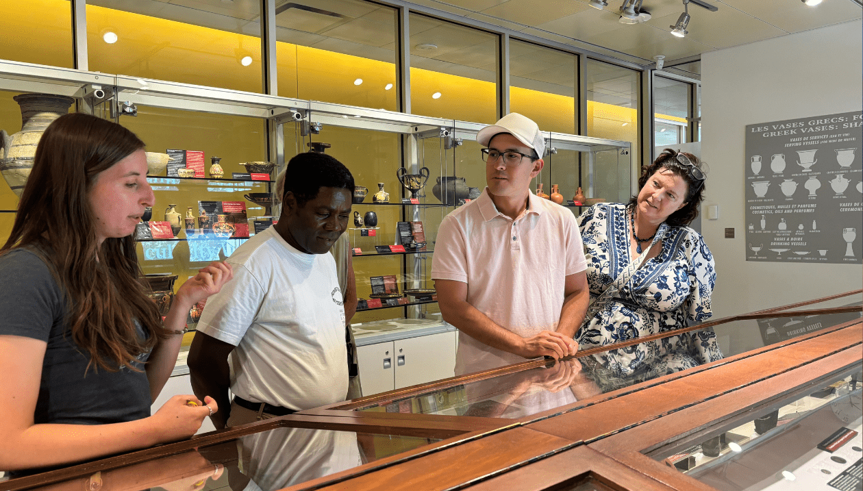 Students learning about ancient artefacts by museum curator.