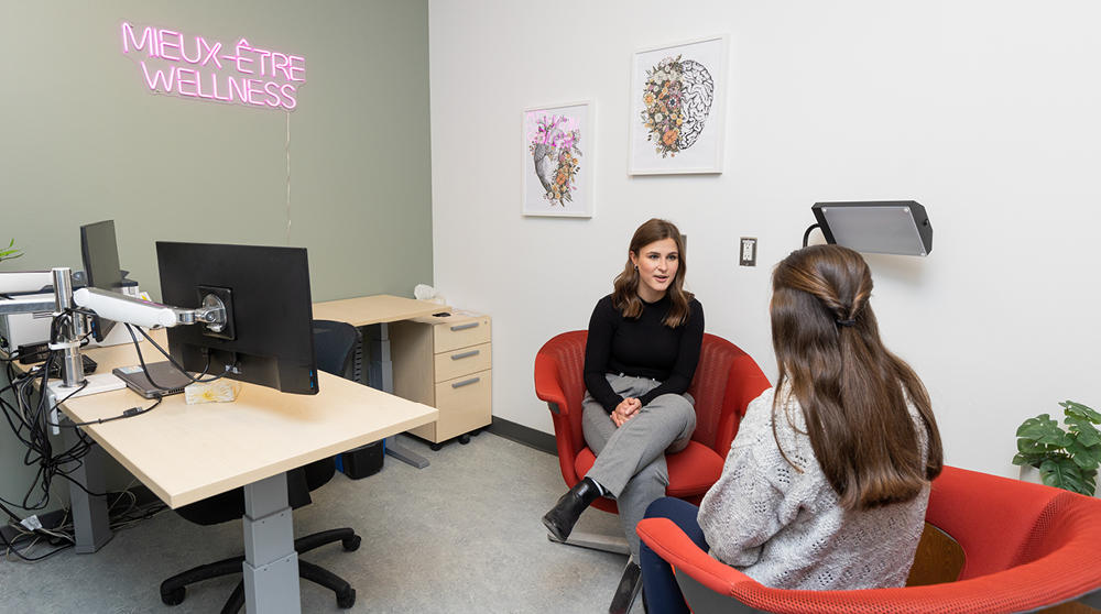 A student sits with a counsellor.