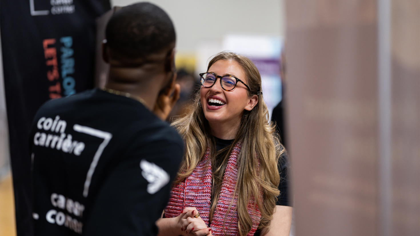 A student laughs as she talks with a counsellor at the Career Corner.
