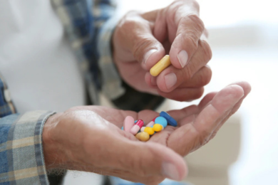 elderly person taking pills