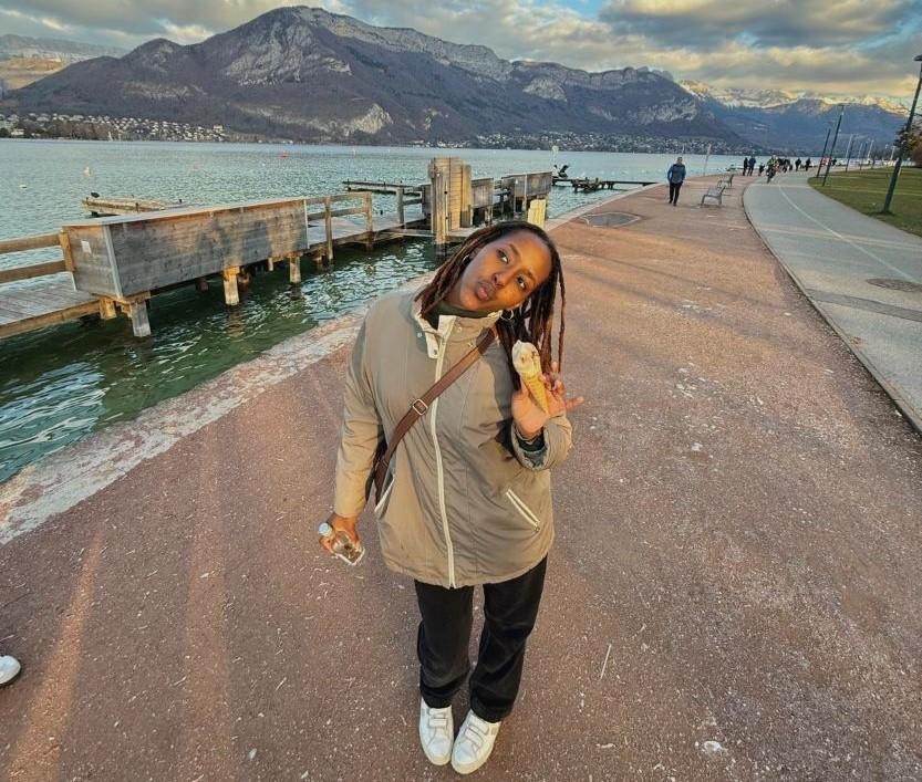 Mukazi standing in a Swiss landscape.