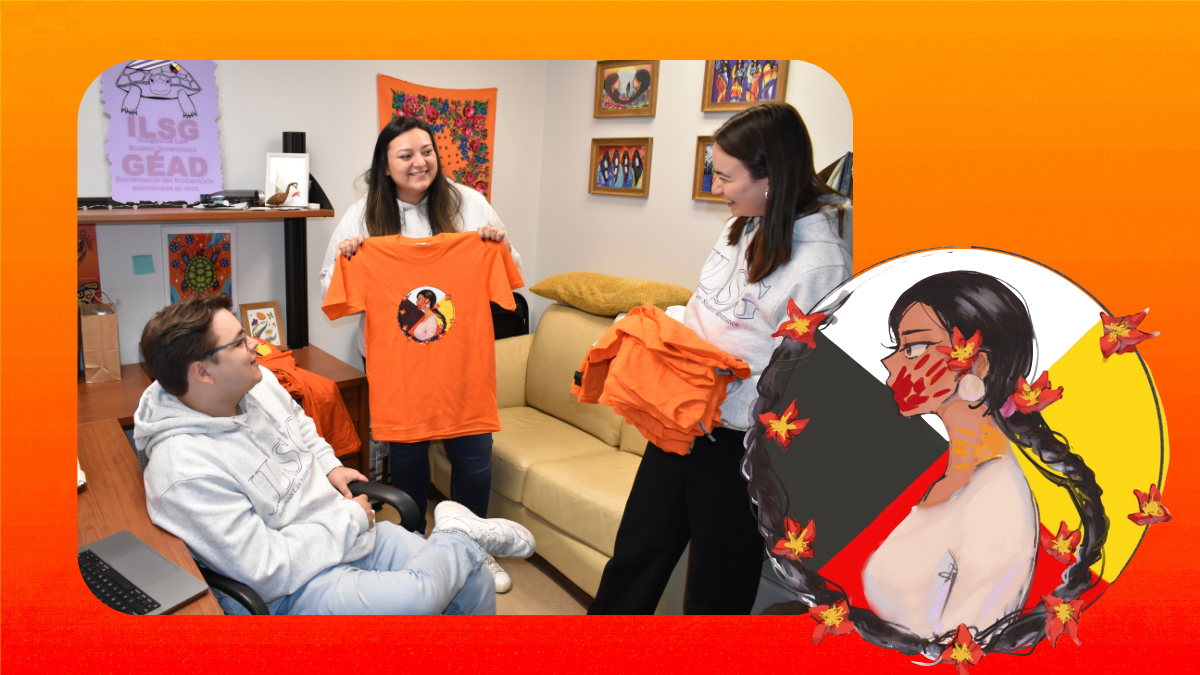 Three people in an office, two are standin.g one is sitting. Two are holding orange shirts and one is showing the design to the others