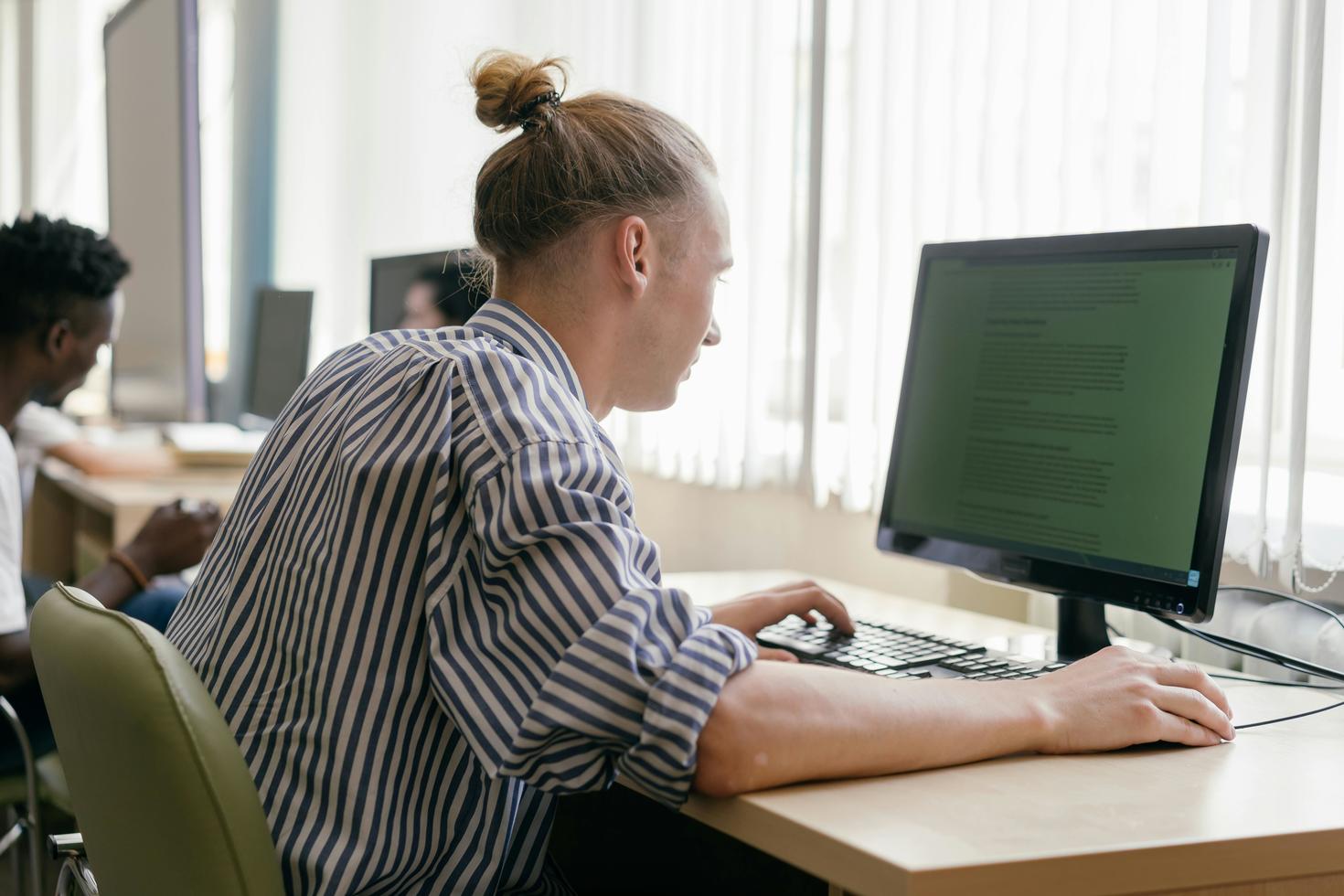 A student looking at a computer screen