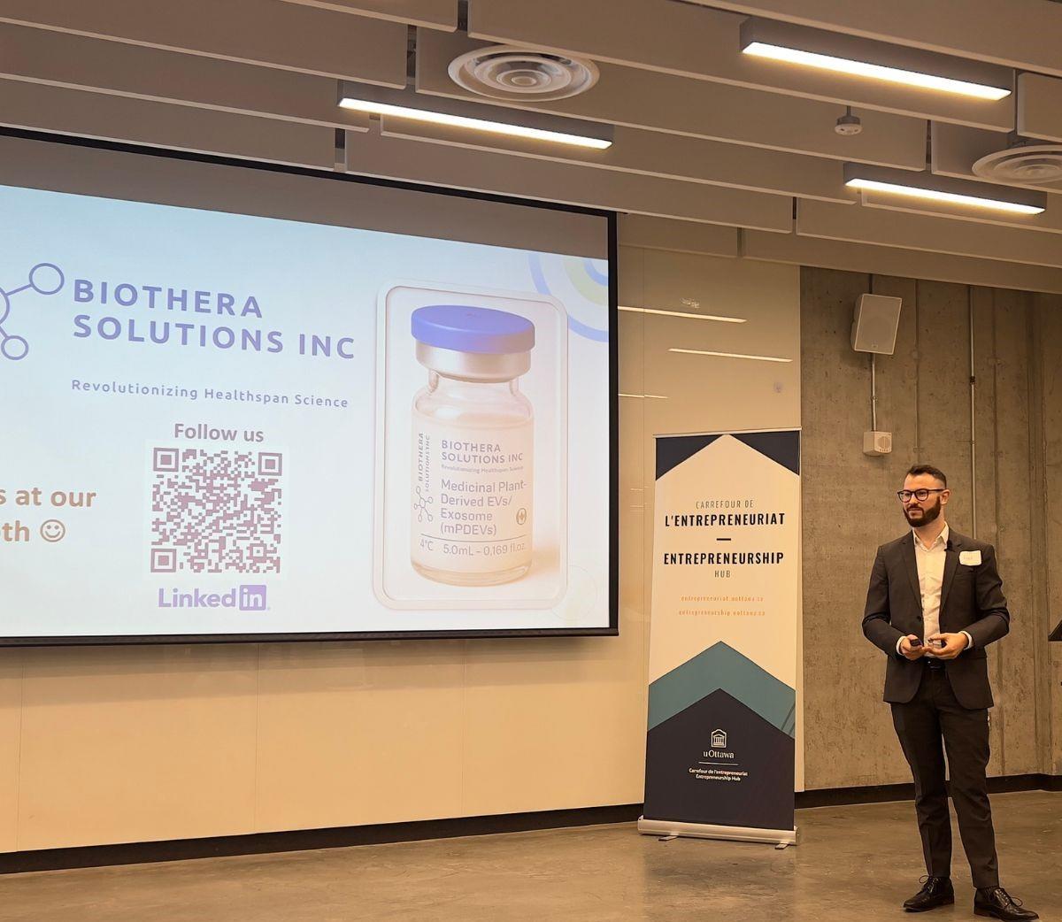 Frédéric St-Denis-Bissonnette, CEO of BioThera, giving a presentation on stage.
