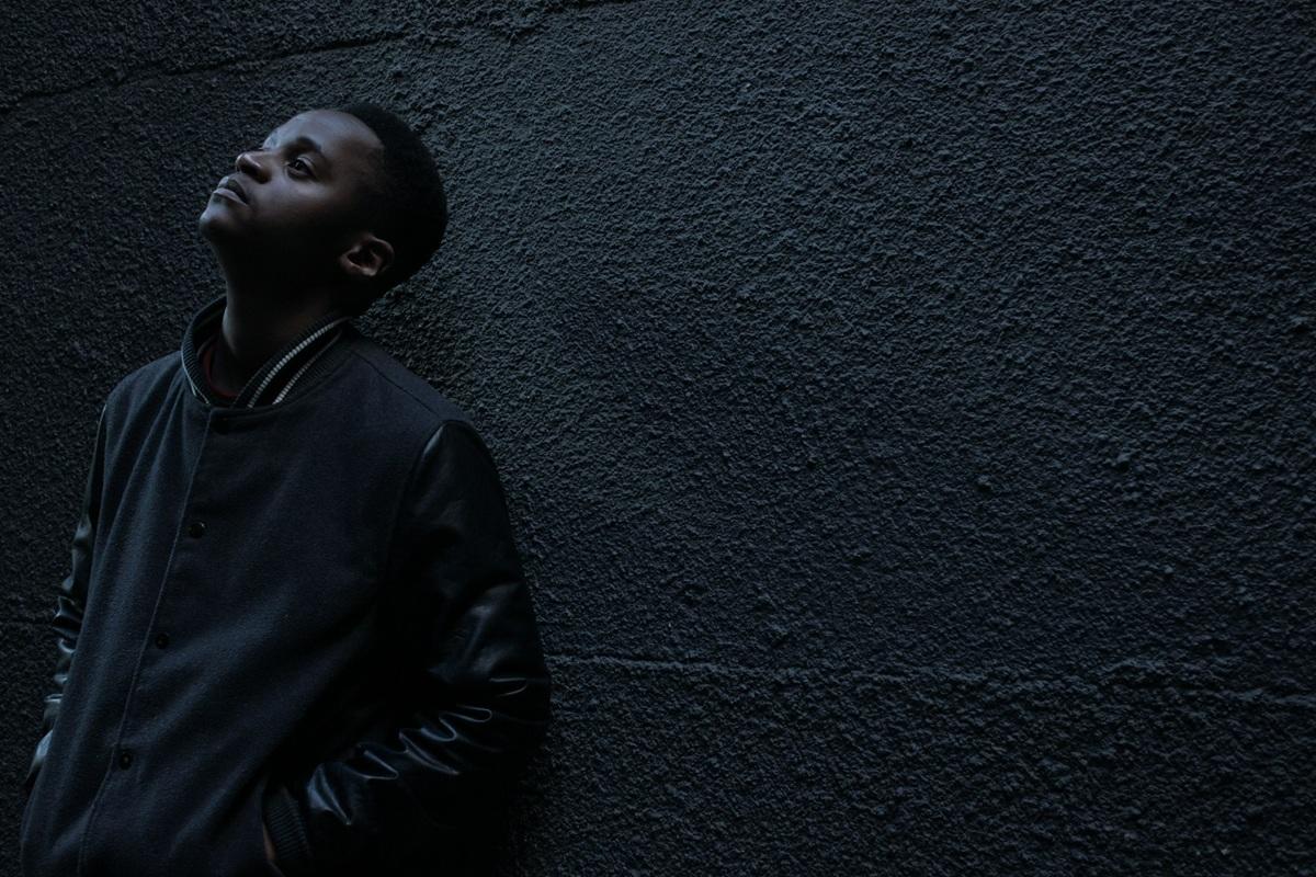 Young black man looking pensively