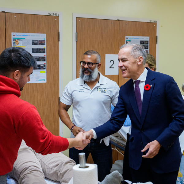 Carney shaking hands