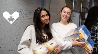Two students working at the Food Bank
