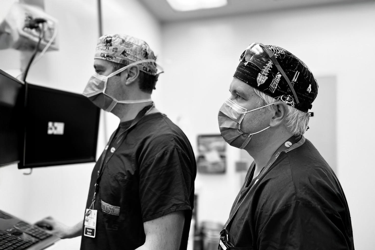 two surgeons preparing for a surgery in a hospital room