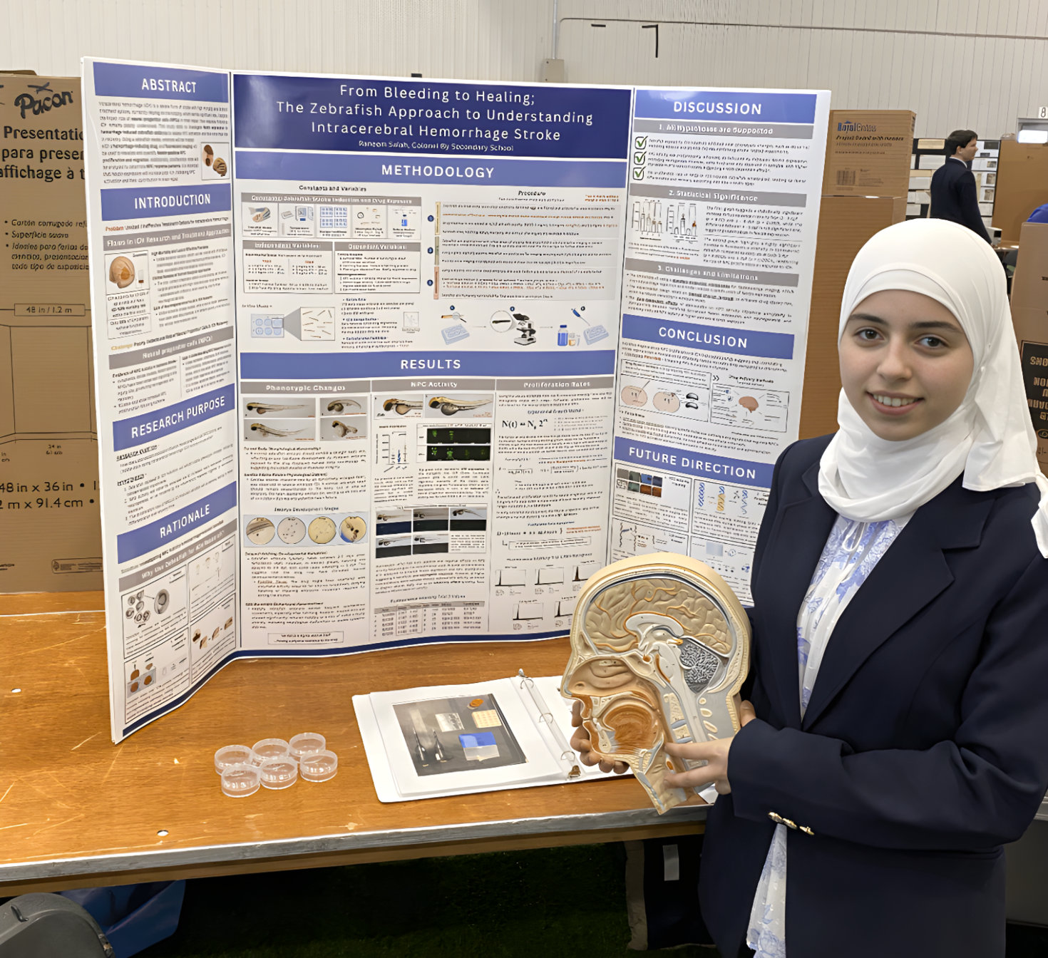 Raneem Salah standing in front of her poster at the regional poster competition