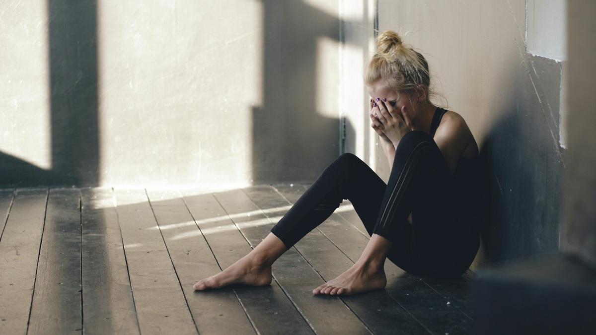Woman sitting on the floor crying