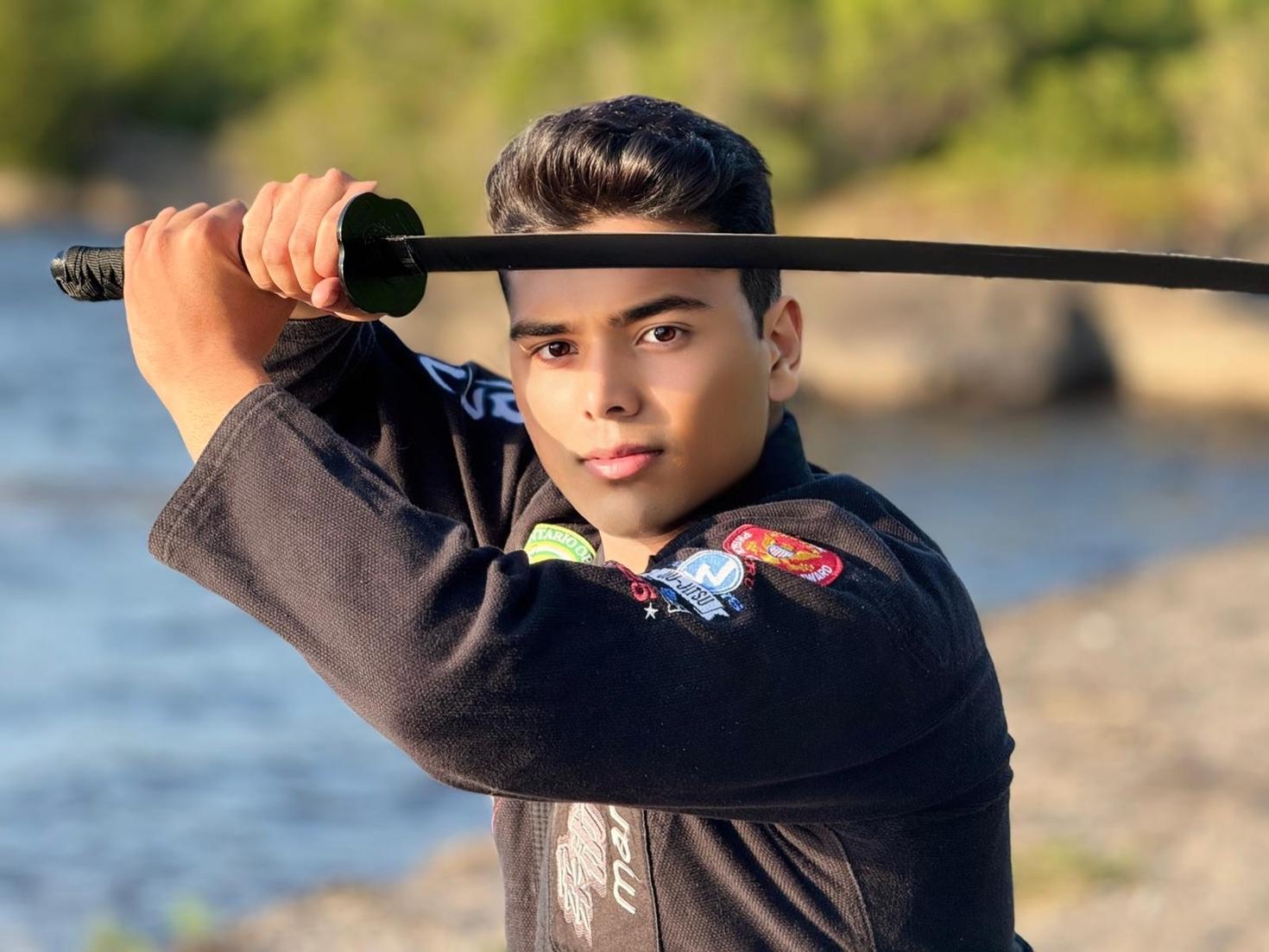 Moiz Lakhani posing, and holding a katana.